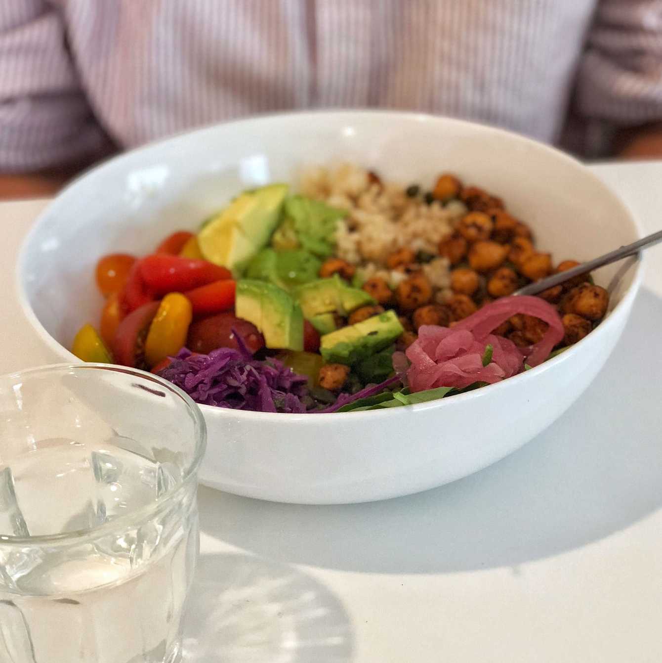 A salad bowl with avocado, tomatoes, couscous and chickpeas