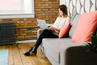 a Capsule team member working from a couch in the office.