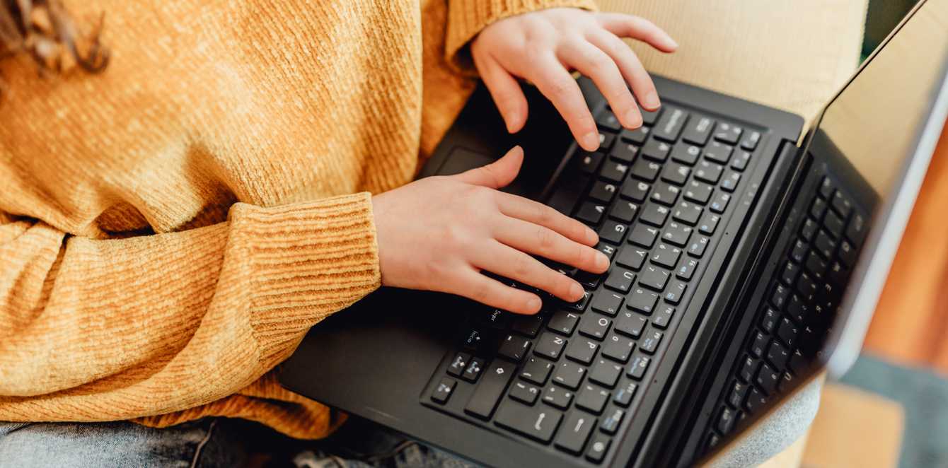 Woman typing on a laptop