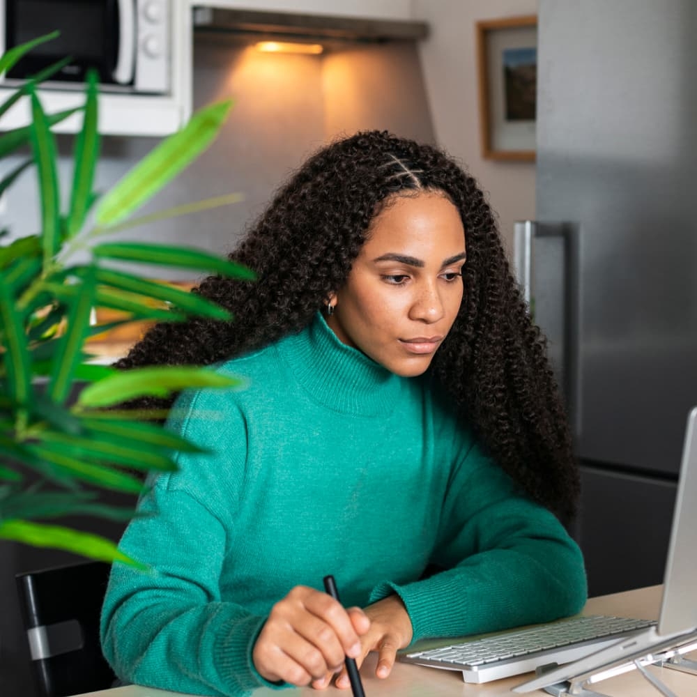 Person sitting at a desk looking at their computer