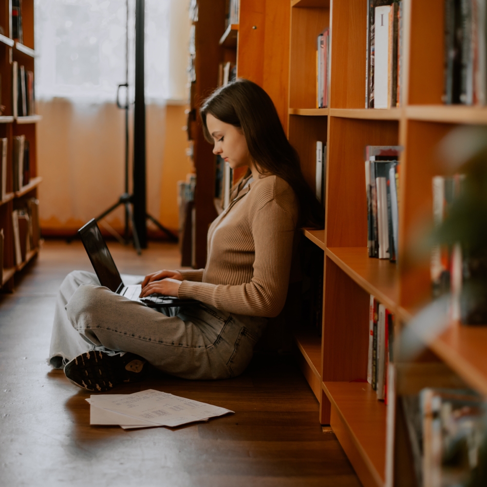 Girl sat on the floor with a laptop